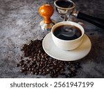 Coffee cup and beans with ground coffee on  gray background, Black coffee cup aromatic and making equipment, Tamper, Filter Basket