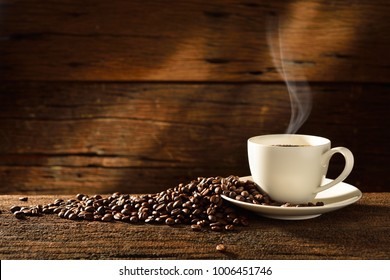 Coffee cup and coffee beans on old wooden background - Shutterstock ID 1006451746