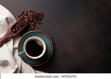Coffee cup and beans on old kitchen table. Top view with copyspace for your text - Powered by Shutterstock