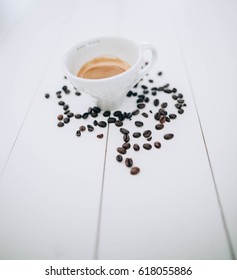 Coffee cup and coffee beans on table