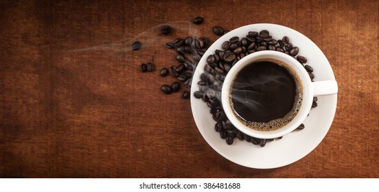Coffee cup and coffee beans on table,banner free space for your text.