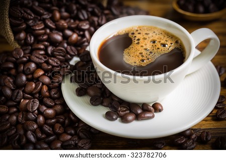 Coffee Cup and Beans on Wooden Table