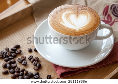 Coffee cup of Cafe' latte with heart latte art on top