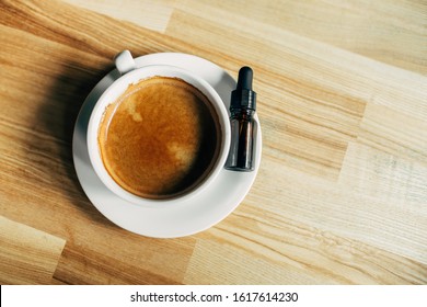 Coffee cup and cannabis CBD oil