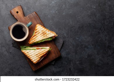 Coffee cup and club sandwich. Breakfast meal. Top view with copy space - Powered by Shutterstock