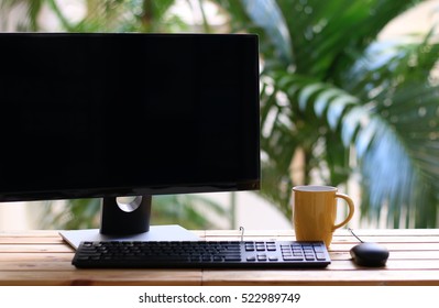 Coffee cup and Computer, Desktop PC. for business blank screen at home copy space.concept of work relax.