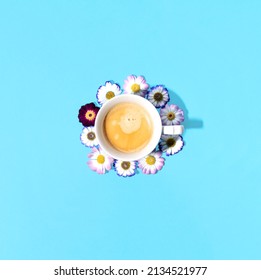 Coffee Cup And Daisy Flowers, Creative Floral Arrangement Against Bright Blue Background. Good Morning Happy First Day Of Spring Inspiration. 