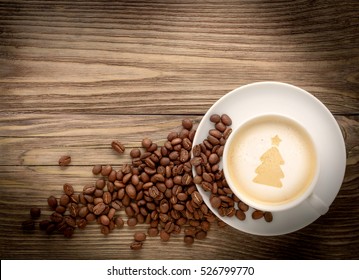 Coffee Cup With Drawing Christmas Tree And Coffee Beans On Wooden Background Flat Lay. Winter Coffee Shop Background