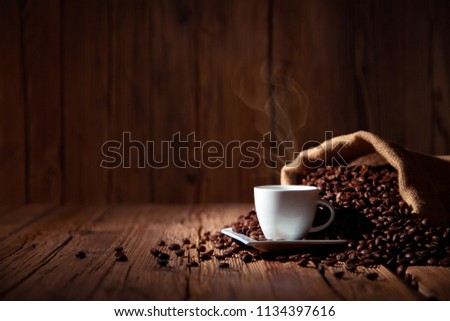 Coffee cup espresso with coffee beans and wooden background