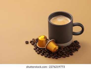 Coffee cup with fresh raw beans and coffee capsules on beige plate. 
