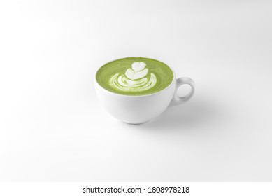 coffee cup with green matcha latte art isolated on a white and gray background closeup. template for drink menu of cafe and restaurant with natural shadow