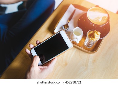 coffee cup and hand  using smart phone,Top view,business