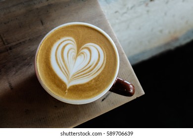 Coffee Cup With Latte Art On The Wood Table.