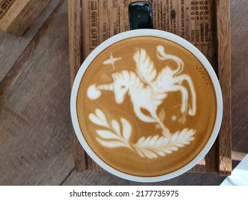 Coffee Cup With Latte Art Unicorn Painting On Wooden Table