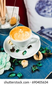 Coffee Cup Latte Foam Arts In Heart Shape With Props By Stylist, Lay On Blue Wood Table.