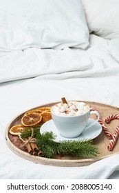 Coffee Cup With Marshmallow, Candy Cane, Christmas Decorations On The Bed. Winter Holiday Mood. Christmas Morning, Coffee Time.