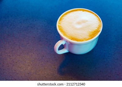 Coffee Cup With Milk Foam On Table