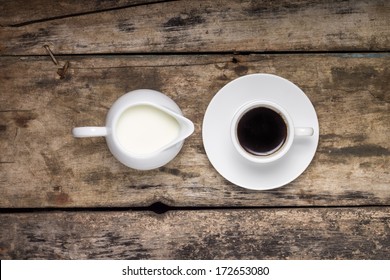 Coffee. Cup Of Coffee With Milk Jug On Wood Background. Top View