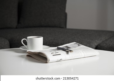 Coffee Cup And Newspaper On The Table