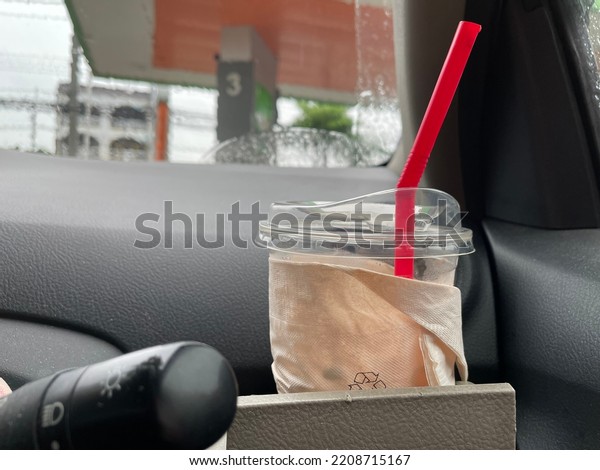 coffee cup on car dashboard at gas station. Space\
for text