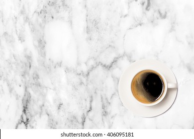 coffee cup on marble table background, top view.