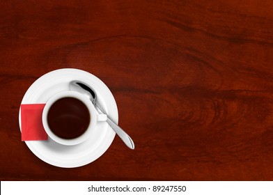 Coffee cup on red table with sugar and a spoon