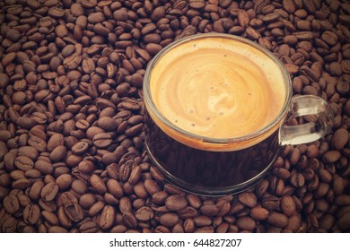 Coffee cup on roasted coffee beans
