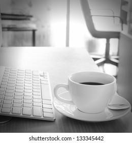 Coffee Cup on the Table with Computer Keyboard for Business Concept.