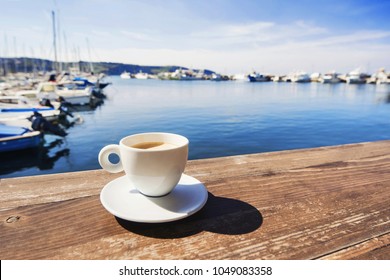 Coffee Cup On A Wood Table Over Blue Sky And Sea Background. Summer Fun, Enjoying Life, Vacations, Holidays, Tourism, Travel Concept