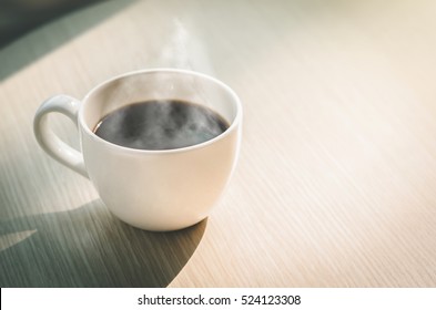 Coffee Cup On Wood Table In Cafe(Vintage Tone)