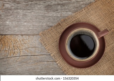 Coffee Cup On Wooden Table Texture. View From Above