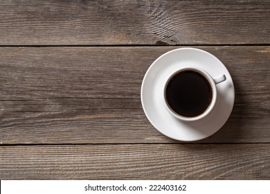 Coffee Cup On Wooden Table. View From Top 