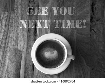 Coffee Cup On A Wooden Table With Text :See You Next Time!