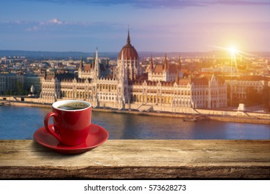 Coffee In Cup On Wooden Table Opposite A View Of Budapest City.