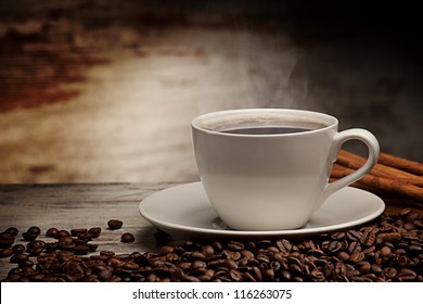 Coffee cup over grunge wooden background - Shutterstock ID 116263075