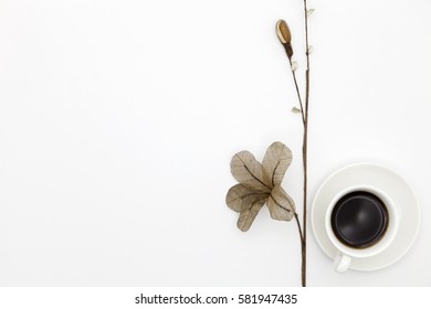 coffee cup with paper flower on white paper background