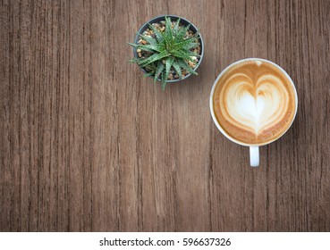 Coffee Cup With Plant Top View On Old Wooden