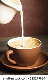 Coffee Cup  And A Pouring Milk