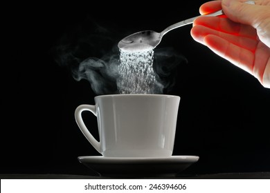 Coffee Cup And Pouring Sugar Spoon On White Background