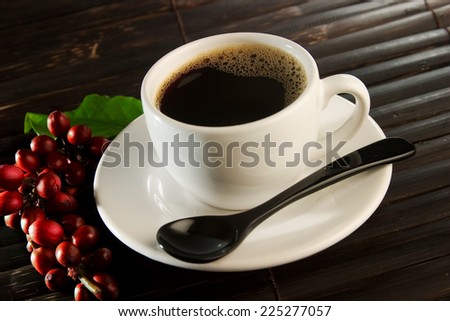 Coffee cup with red coffee beans