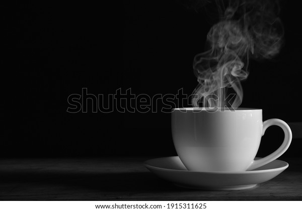 coffee\
cup smoke black background Black and white\
photo