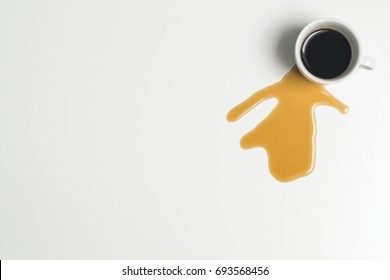 Coffee Cup And Spilled Coffee On A White Background. View Is From Above.