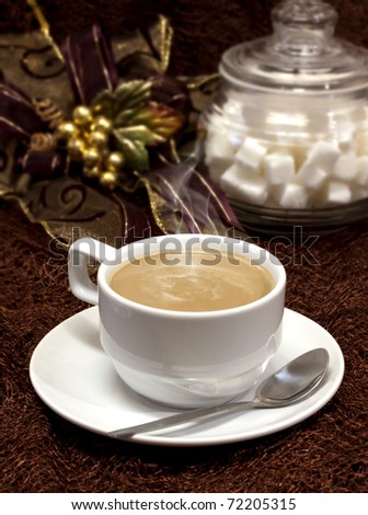 coffee cup and spoon on brown background and white sugar