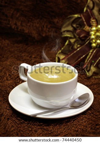 coffee cup and spoon on brown background