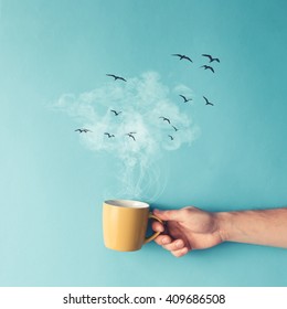 Coffee cup with steam, clouds and birds. Coffee concept. Flat lay. - Shutterstock ID 409686508