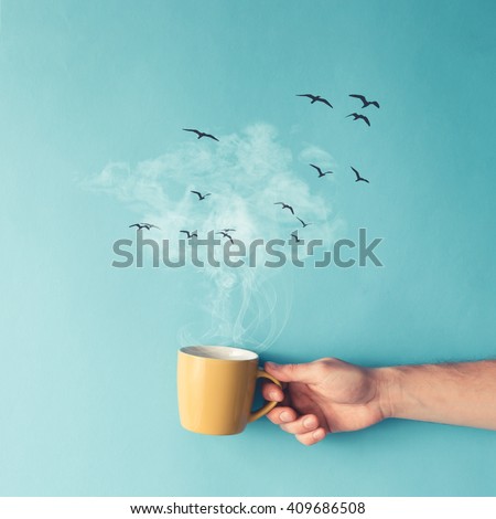 Coffee cup with steam, clouds and birds. Coffee concept. Flat lay.