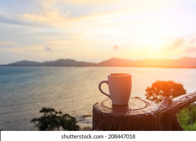 Coffee cup and sunset - Shutterstock ID 208447018