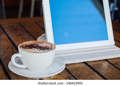 Coffee cup and tablet