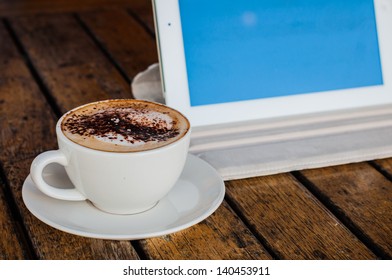 Coffee cup and tablet