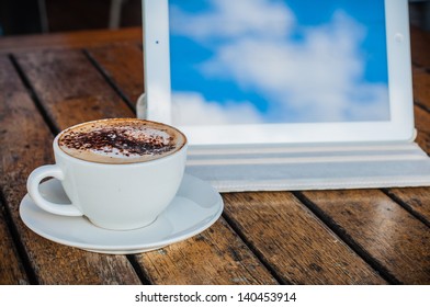 Coffee cup and tablet
